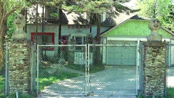 Front of Mary Nohl house and environment, with fortifications (Fox Point, Wisconsin, circa 1990) 26PG of Nohl yard sculpture
