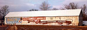Vintage Please Mr. Balch sign of a long dog on a long barn in Enfield, CT