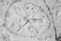 Skull on autograph rock with Genny, Joe G and others, detail. Lost. Chicago lakefront stone carvings between Belmont and Diversey Harbors. 2002