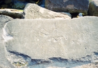 JHB and other initials, checkboard patterns.  Lost. Chicago lakefront stone carvings between Diversey and Belmont Harbors. 2002