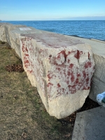 Faded red painting. Chicago lakefront stone painting, between Belmont and Diversey Harbors. 2024