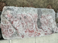 Faded red painting. Chicago lakefront stone painting, between Belmont and Diversey Harbors. 2024