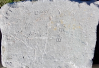 Autograph rock: Lee, Joe, Dan, Baba, V, DGE, FL. Chicago lakefront stone carvings, between Belmont and Diversey Harbors. 2019
