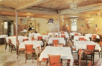 The table-and-chairs shot is one of the oddball conventions of commercial postcards. Did they really expect anyone to say, "Get a load of those tables, we've got to eat there!" But check out that ceiling and the light fixtures in this one