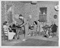 Not satisfied with creating bottle cap murals for his walls, owner Joe Wiser and his wife created draperies for the windows as well.  MIAMI, FLA: DEC-00-1940: The patience of Job, the friendliness of hundreds of delivery truck drivers as collectors and contributors has enabled Joe Wiser and his wife to build "Bottle Cap Inn" a bar in Miami at 1290 N. W. 119th St., whose walls and ceilings are decorated with over a million bottle caps. It took three years, a ton of nails and a ton of cement to do the job. Bottle caps are everywhere, on the floor, ceiling, bar, clock, lights, chairs, cash register, curtains, and even on the driveway. It's the most unique rendevous in Florida. Caps have been sent by admirers from the four corners of the world. This Photo Gratis for the City of Miami. From Hamilton Wright, Miami News Service