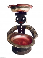 Seated brown bottle-cap figure with painted face and crosspiece on head - vernacular art Seated brown bottle-cap figure with painted face and crosspiece on head - vernacular art