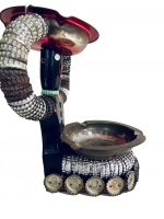 Seated black bottle-cap figure with base lined with Green Bay Packers bottle caps, side view - vernacular art Seated black bottle-cap figure with base lined with Green Bay Packers bottle caps, side view - vernacular art