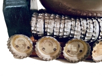 Seated black bottle-cap figure with base lined with Green Bay Packers bottle caps, detail of base - vernacular art Seated black bottle-cap figure with base lined with Green Bay Packers bottle caps, detail of base - vernacular art