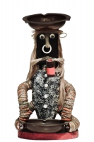 Long-haired seated black bottle-cap figure with glitter and a pipe- vernacular art Long-haired seated black bottle-cap figure with glitter and a pipe- vernacular art