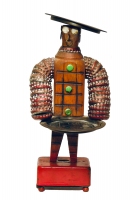 Brown bottle-cap figure with Texas-themed trays standing on a music box - vernacular art