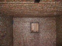Interior of shed covered  with bottle caps - vernacular art environment