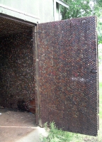 Doorway  of shed covered  inside with bottle cap - vernacular art environment