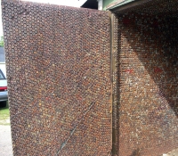 Doorway  of shed covered  inside with bottle cap - vernacular art environment