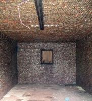 Interior of shed covered  with bottle caps - vernacular art environment