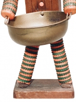 Detail of orange and green legs on the brown bottle-cap figure with carved nose and mouth by the Oshkosh Master - vernacular art