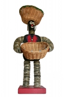 Black bottle-cap figure with felt vest, notebook reinforcers for eyes and mouth, and baskets instead of bowls - vernacular art