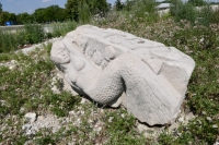 Toppled mermaid. The result of natural forces. Chicago lakefront stone carvings, Oakwood Beach. 2021
