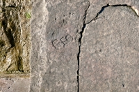 Hand holds tablet or book with star and indecipherable writing. Chicago lakefront stone carvings, Calumet Park. 2019