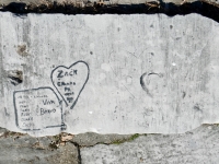 Viva \"Bravo,\" Alma, Norm, Toni, Jackie, Bobby, Charlie, Linda, Emanual, in rectangle (highighted), Zack, Gramma, Pa 01, in heart (highlighted), Bernice and small heart (vertical, lower center) and heart with JR and DW and a drawn heart. Chicago lakefront stone carvings, Calumet Park. 2024