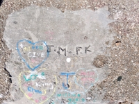 J.M. F.K., arrow, Bob +, FK. Chicago lakefront stone carvings, Calumet Park. 2024