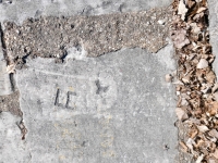 LE, detail. Chicago lakefront stone carvings, Calumet Park. 2024