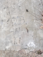 Flaming Dogtown cross, Bob Deligny(?) July 9, 1961 within a shield, Steve and others, detail.  Chicago lakefront stone carvings, Calumet Park. 2020