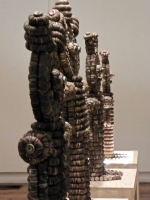 Caparena, Clarence and Grace Woolsey bottle-cap figure at Intuit, sideview of row