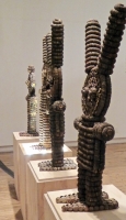 Caparena, Clarence and Grace Woolsey bottle-cap figure at Intuit, sideview of row