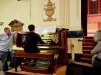 The organ console in the Carl Schurz auditorium. Organ pipes at right