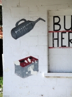 Oil can and battery detail from painted facade, D.J. Auto Sales, next to A Auto Repair-Roadside Art