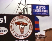 Wall sign of strong man lifting a car, Chicago-Roadside Art