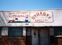 Sign showing cartoonish mechanics. Dynasty, Western Avenue near 43rd Street-Roadside Art