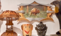 Top shelf center right  from Chicago We Own It: Popsicle  stick lamp, Bruno Sowa buffalo relief,  happy face cookie jar, Lanier Meaders face jug