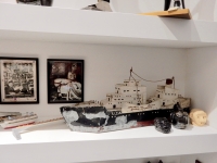 The middle shelf from Chicago We Own It: Joe "40,000" Murphy photos, John Urbaszewski models, ship model, face jugs, sculpted head