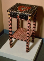 A bottle-cap-covered side table