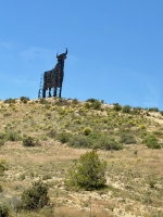 This bull billboard is a ghost sign for a brandy that has since become a popular non-commercial symbol erected on highways across Spain. Look up Osborne Bull on Wikipedia.