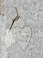 T + Melis. Rest of first name scratched out. Heart with arrow, level 2. Chicago lakefront stone carvings, between Foster Avenue and Montrose. 2017