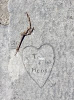 T + Melis. Rest of first name scratched out. Heart with arrow, level 2. Chicago lakefront stone carvings, between Foster Avenue and Montrose. 2017 T + Melis. Rest of first name scratched out. Heart with arrow, level 2. Chicago lakefront stone carvings, between Foster Avenue and Montrose. 2017