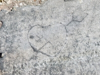 Heart with arrow. Chicago lakefront stone carvings, between Foster Avenue and Montrose. 2018