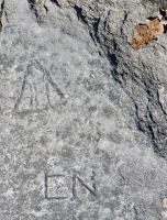 Sailboat, or triangle containing AHA, CN, level 1. Chicago lakefront stone carvings, between Foster Avenue and Montrose. 2017