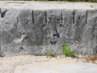 Face drawn on rock above Weewee, detail. Chicago lakefront rock drawings, Montrose Beach. 2022