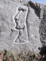 Three enigmatic figures, Easter Island style, detail, near the Hair Washers. Signed RS 08. Chicago lakefront stone carvings at Fullerton. 2024