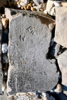 Deteriorated rock with RW, Dorothea Nathan, 1962, detail. Chicago lakefront stone carvings, behind La Rabida Hospital, 65th Street and the Lake. 2021