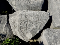 Peace rock: peace symbol, peace sign, footprint, butterfly, flowers, Leo, Kris, Pat, Audrey,  Mark, Larry. Chicago lakefront stone carvings, behind La Rabida Hospital, 65th Street and the Lake. 2018