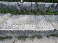 Mayan bird deity with a hummingbird and large Xs. Signed "595PT/JUH," September 1995. Based on a panel from the Temple of the Foliated Cross in the Maya archaeological site at Palenque. Chicago lakefront stone carvings between Foster Avenue and Bryn Mawr. 2023