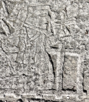 FIgure approaches seated Mesoamerican skeleton, detail. Chicago lakefront stone carvings between Foster Avenue and Bryn Mawr. 2013 FIgure approaches seated Mesoamerican skeleton, detail. Chicago lakefront stone carvings between Foster Avenue and Bryn Mawr. 2013