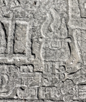 UJH 59 in figure approaching seated Mesoamerican skeleton, detail. This carver typically reversed his numbers and letters. Chicago lakefront stone carvings between Foster Avenue and Bryn Mawr. 2013. UJH 59 in figure approaching seated Mesoamerican skeleton, detail. This carver typically reversed his numbers and letters. Chicago lakefront stone carvings between Foster Avenue and Bryn Mawr. 2013.