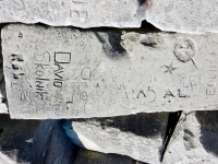 The cursive script is overwritten on this autograph rock with cross and star, David Skolnik, Rob, 1935. Chicago lakefront stone carvings, behind La Rabida Hospital, 65th Street and the Lake. 2018