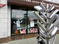 Muffler tree and window at 3 Stars Auto Body in November 2011, Lawrence Avenue near Sacramento