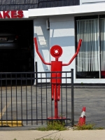 Repainted shop, now called Sun Auto Works, and muffler man, Lawrence Avenue at Kenneth. The abstract face is a nice touch